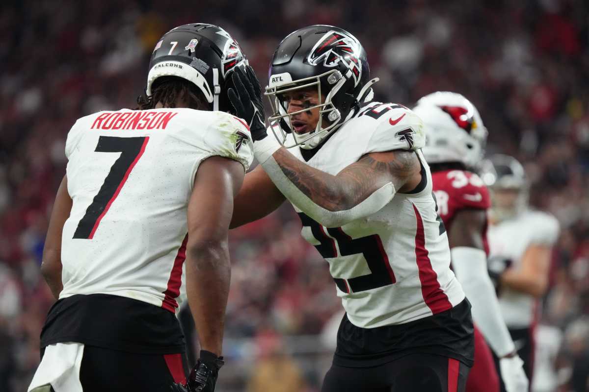 Atlanta Falcons running back Tyler Allgeier (25) congratulates teammate Bijan Robinson (7) on his touchdown against the Arizona Cardinals at State Farm Stadium.